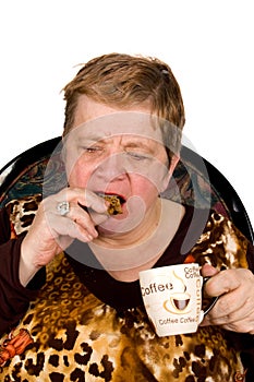 Elderly woman is drinking coffee