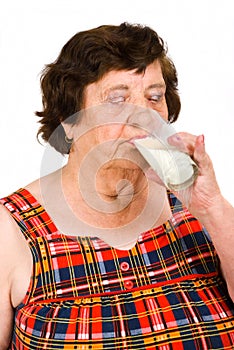 Elderly woman drinking milk