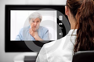 Elderly Woman with dyspnea, Doctor looking at the desk, telemedicine and telehealth with live chat photo