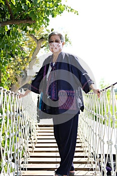 Elderly woman elder wearing facial mask resting relaxing outdoors. senior leisure lifestyle