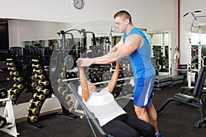 An elderly woman, eldest is engaged in sports in gym. Muscles swing barbell. Retired concept, healthy lifestyle, indoor