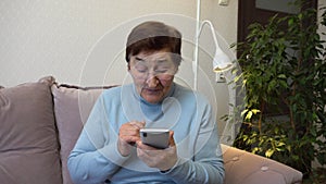 Elderly Woman Embraces Video Calls with Smartphone