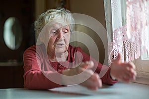 Elderly woman emotionally reacts by telling