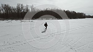 elderly woman engaged in Nordic walking with sticks in the winter forest. Healthy lifestyle concept. Mature