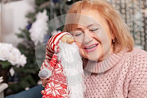 Elderly woman enjoying Christmas Eve at home