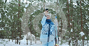 An elderly woman enjoys retirement in a snowy winter forest.
