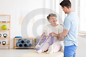 Elderly woman exercising with band