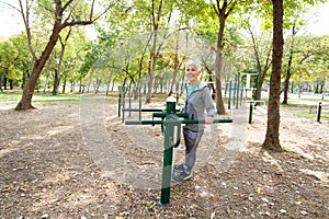 Elderly Woman Exercising At Public Sports Park