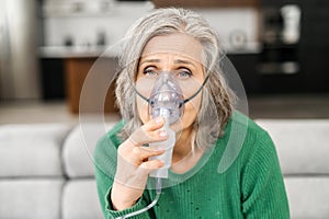 Elderly woman fells bad, holing a oxygen mask, lacking of oxygen