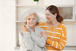 Elderly woman with female caregiver