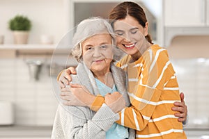 Elderly woman with female caregiver