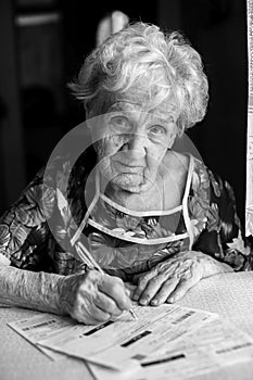 Elderly woman fills in receipts for utilities. Help.