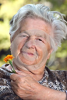 Elderly woman with flower