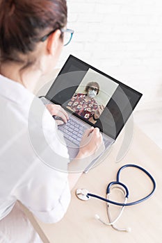 An elderly woman with the flu for an online consultation with a doctor. Female practitioner makes a video call with a