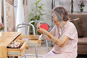 Elderly woman found her lost wallet in drawer. Dementia concept