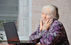 The elderly woman in front of the laptop