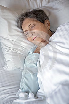 Elderly woman getting a good nights rest.