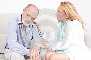 Elderly woman giving support to her partner