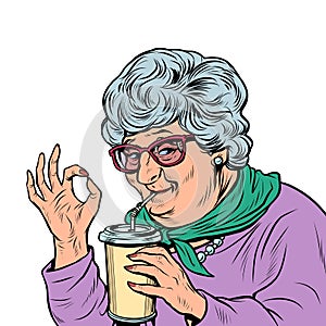 elderly woman granny drinks a coke drink, ok gesture