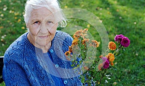 Elderly woman on green meadow