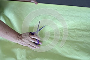 Elderly Woman Hand With Scissors On Paper