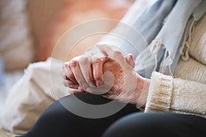 Elderly woman hands clasped retirement concept