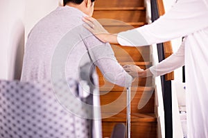 Elderly woman hands holding sticks while walking up stair at home,Caregiving take care and support,Self-Care for Family Caregivers