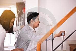 Elderly woman hands holding sticks while walking up stair at home,Caregiving take care and support,Self-Care for Family Caregivers