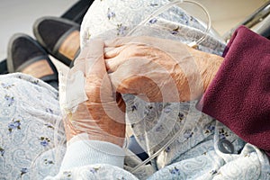 Elderly woman hands with intravenous drip