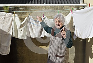 Elderly woman hanging out the washing