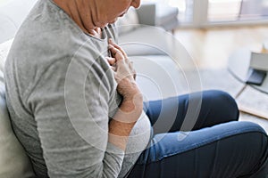 Elderly woman with heart pain holding her chest