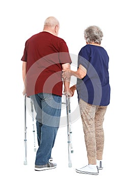 Elderly woman helping her husband with walking frame