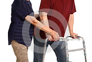 Elderly woman helping her husband with walking frame on white background