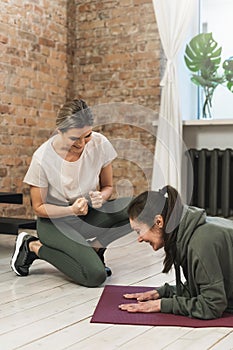 elderly woman during her fitness workout with personal trainer in gym