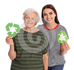 Elderly woman and her granddaughter with recycling symbols on background