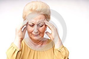 Elderly woman hold hands on her sore head