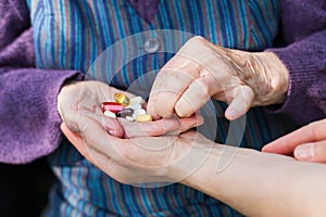 Elderly woman holding medical drugs