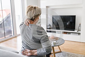 Elderly woman at home with back pain