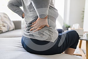 Elderly woman at home with back pain