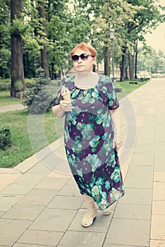 Elderly woman ice cream sit park summer