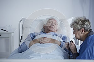 Elderly woman and ill husband