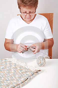 Elderly woman knitting