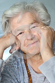 Elderly woman leaning on hands