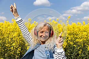 Elderly Woman listen to music in summer