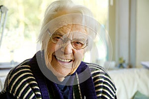 Elderly woman looking at the camera and smiling