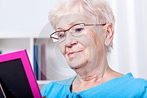 Elderly woman looking at photography