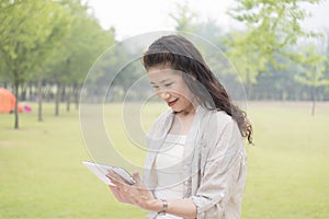 Elderly woman looking Tablet