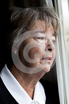 Elderly woman lost in thought