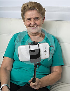 Elderly woman making self-photos