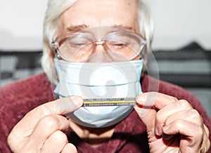 Elderly woman in a medical mask. The epidemic